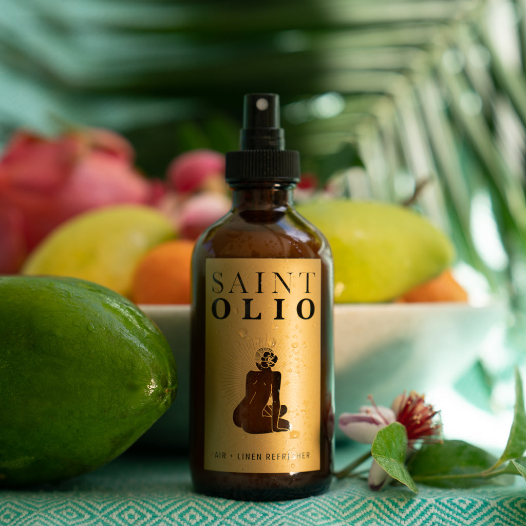 Saint Olio Air + Linen Refresher, Cala scent, in an amber spray bottle with tropical fruit