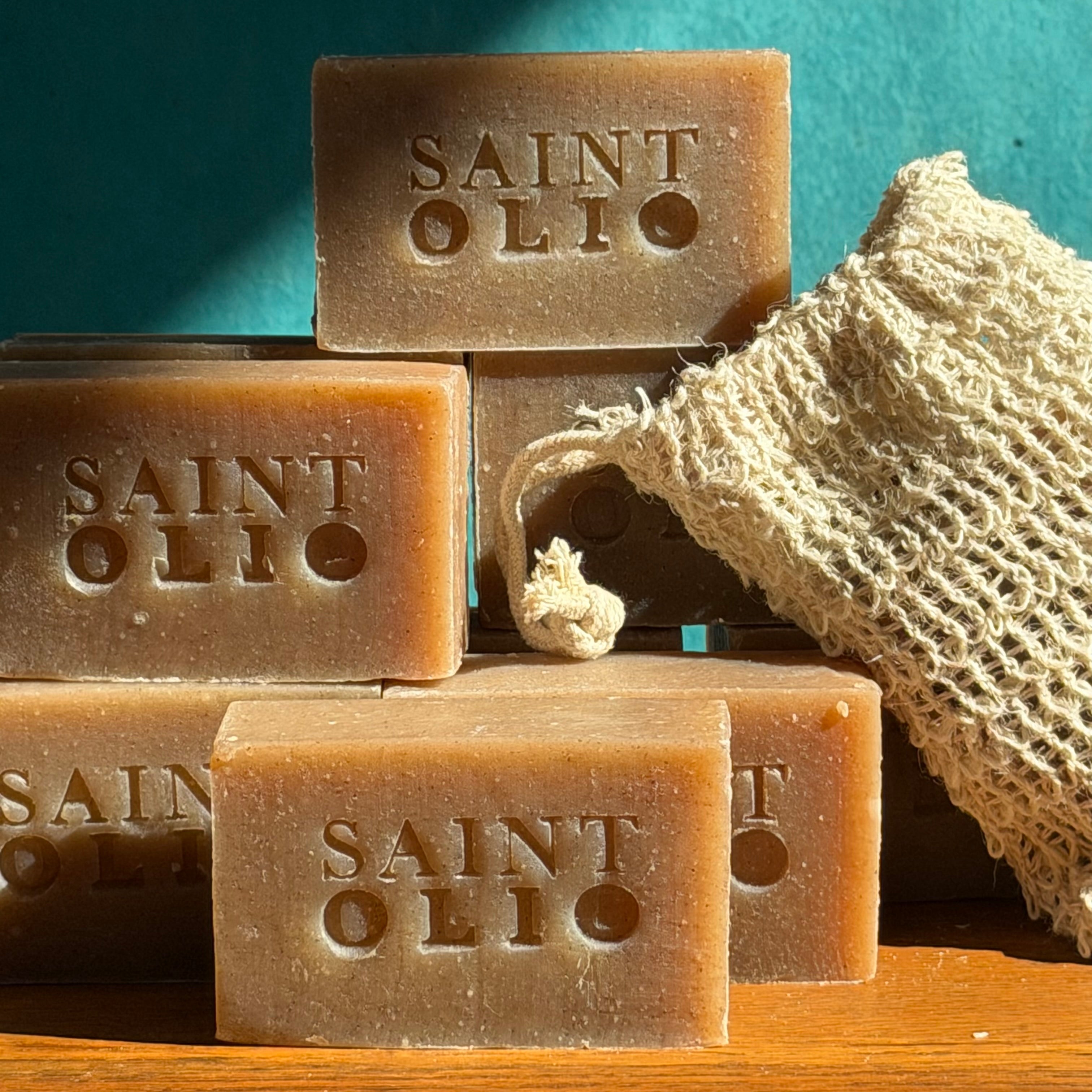 Saint Olio natural dog shampoo bars stacked with a sisal soap saver bag